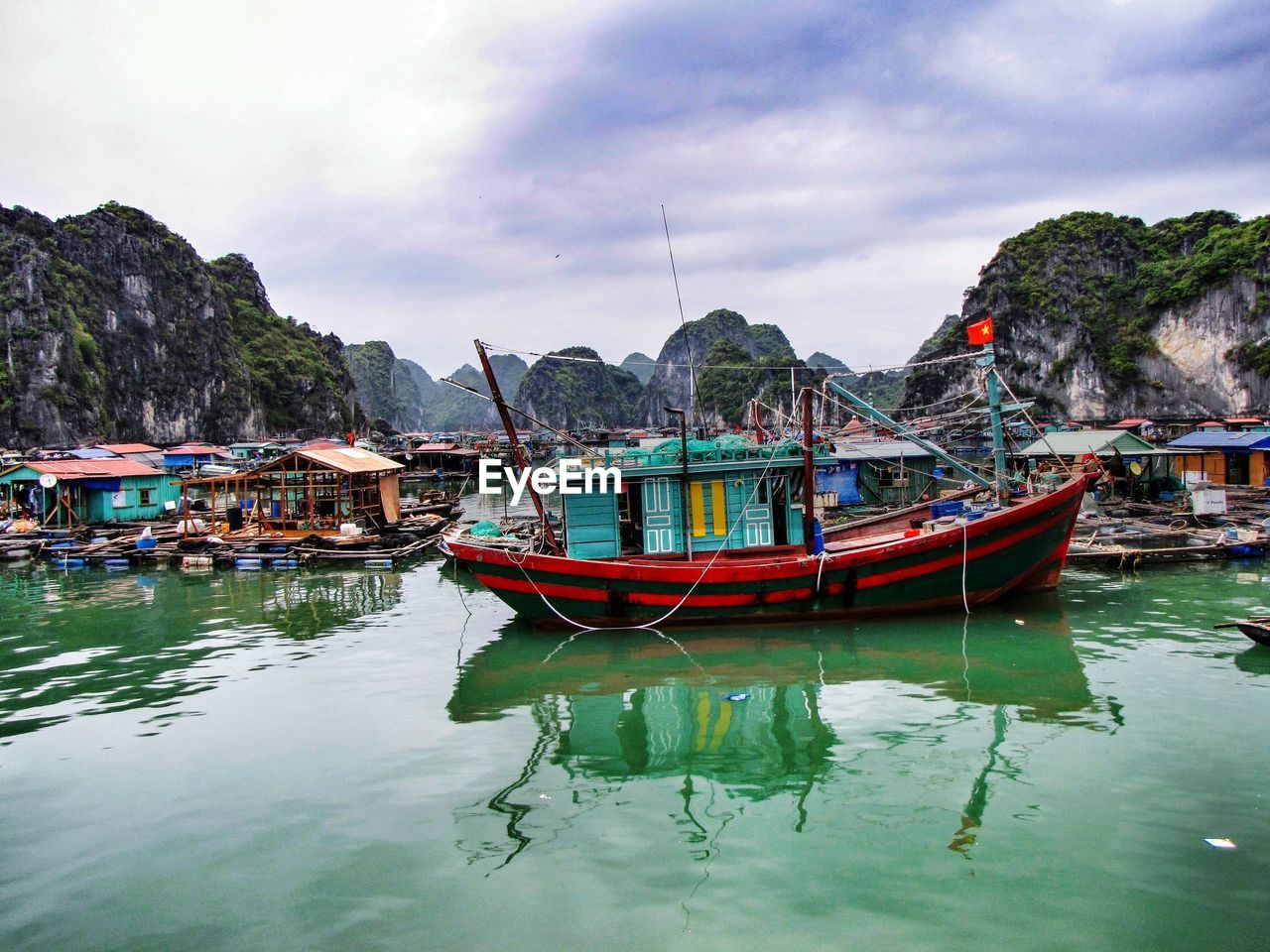 water, nautical vessel, transportation, sea, mode of transportation, boat, nature, sky, travel, boating, travel destinations, bay, land, moored, cloud, reflection, vehicle, mountain, beach, beauty in nature, environment, tranquility, architecture, landscape, scenics - nature, tourism, no people, outdoors, trip, long-tail boat, coast, harbor, holiday, vacation, fishing, ship, tradition, tropical climate, watercraft, city, day, tranquil scene, idyllic, fishing industry, fishing boat, building, waterfront, building exterior, coastline, multi colored, village, bay of water