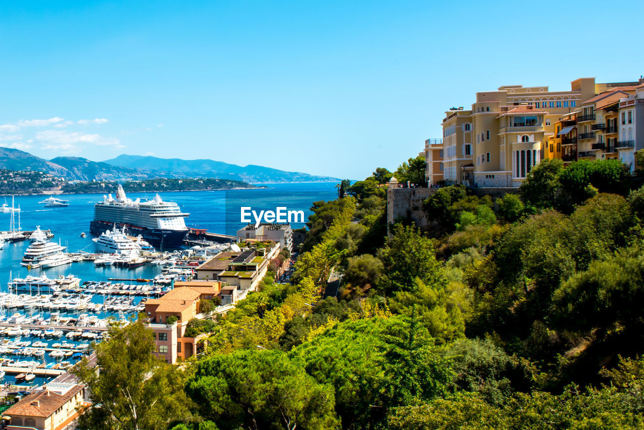 Harbor view with cruise ship against blue sky