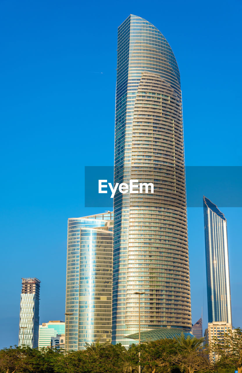 LOW ANGLE VIEW OF BUILDINGS AGAINST CLEAR BLUE SKY