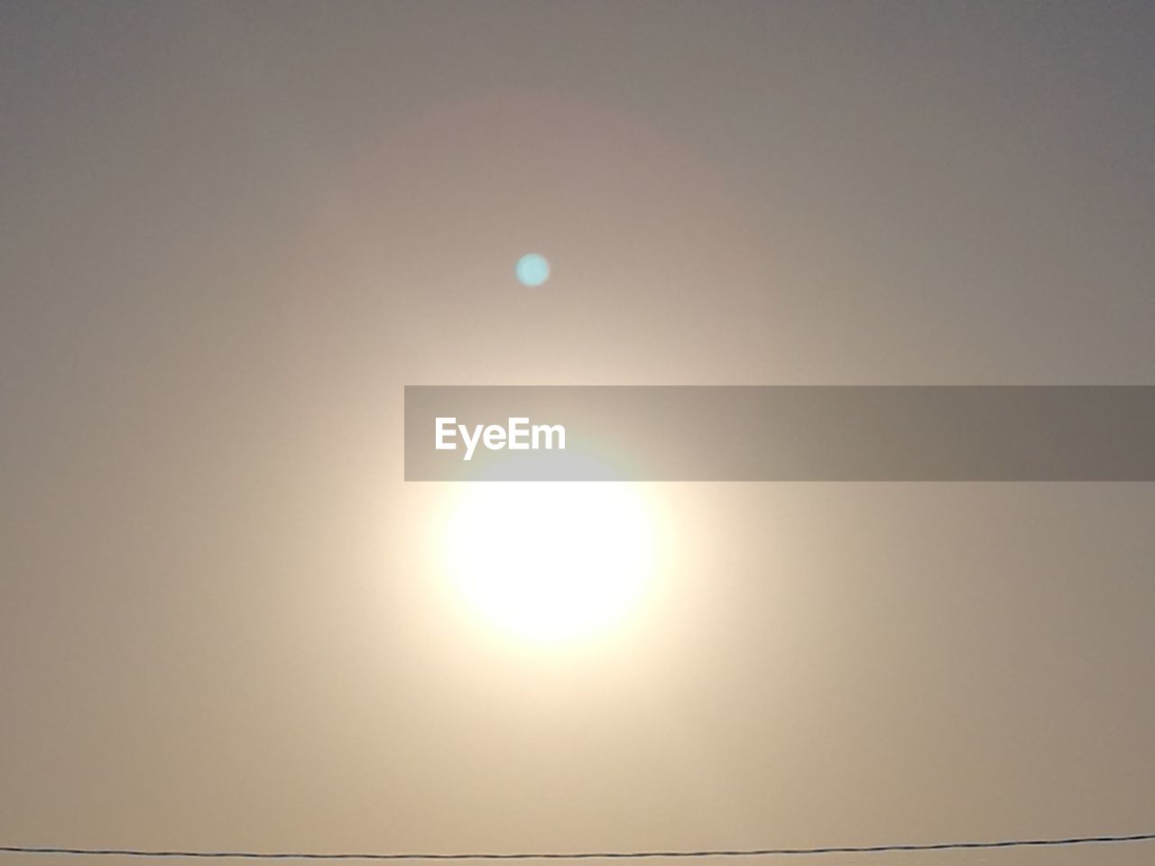 SCENIC VIEW OF SUN AGAINST SKY AT SUNSET