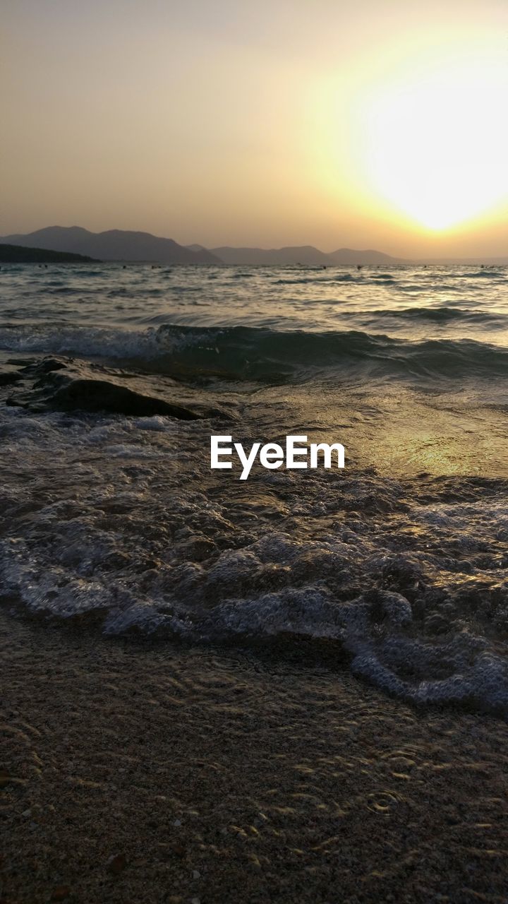 SCENIC VIEW OF BEACH DURING SUNSET