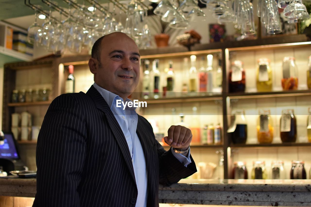 Smiling mature man sitting in restaurant