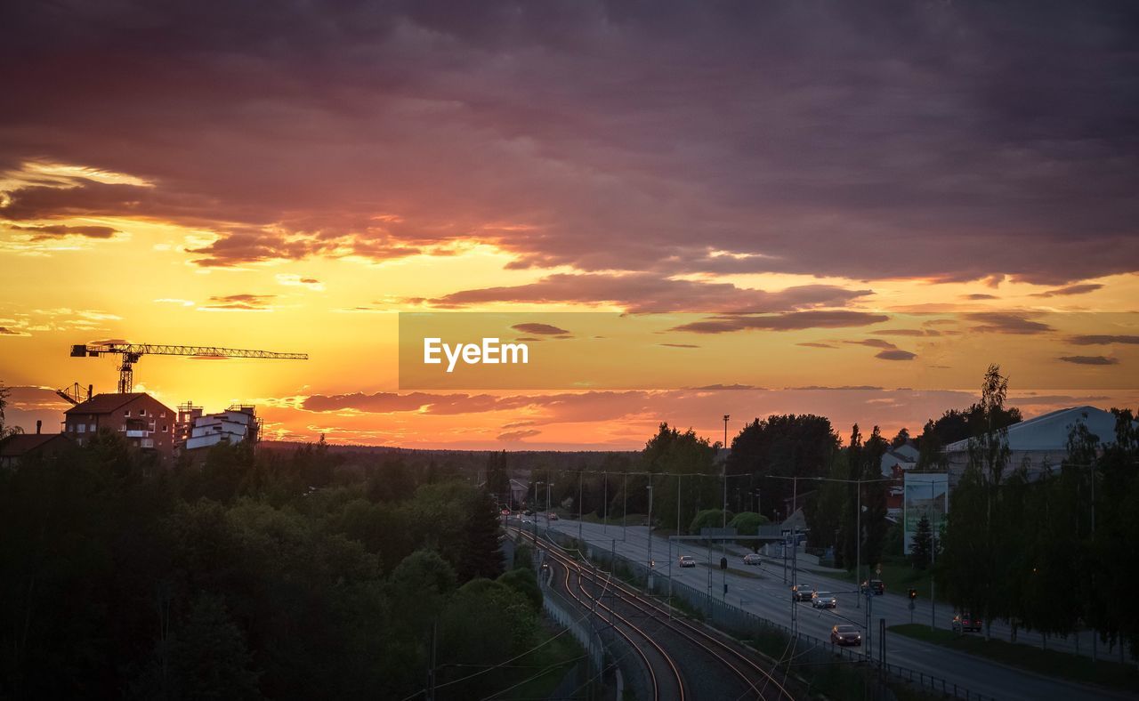 HIGH ANGLE VIEW OF RAILROAD TRACKS DURING SUNSET