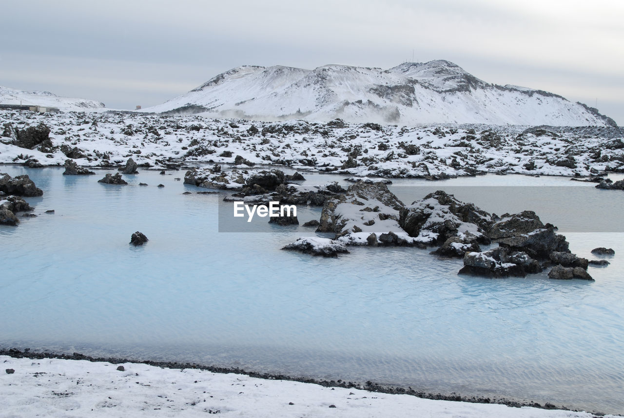 Scenic view of frozen lake against sky