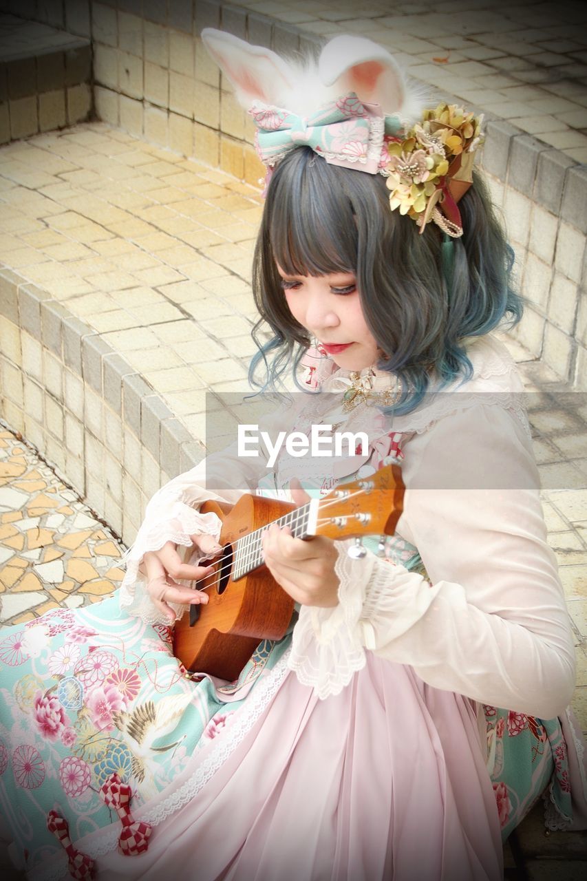 High angle view of girl playing music 