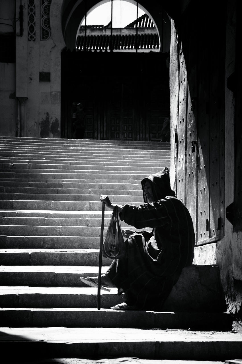 Senior man sitting on steps