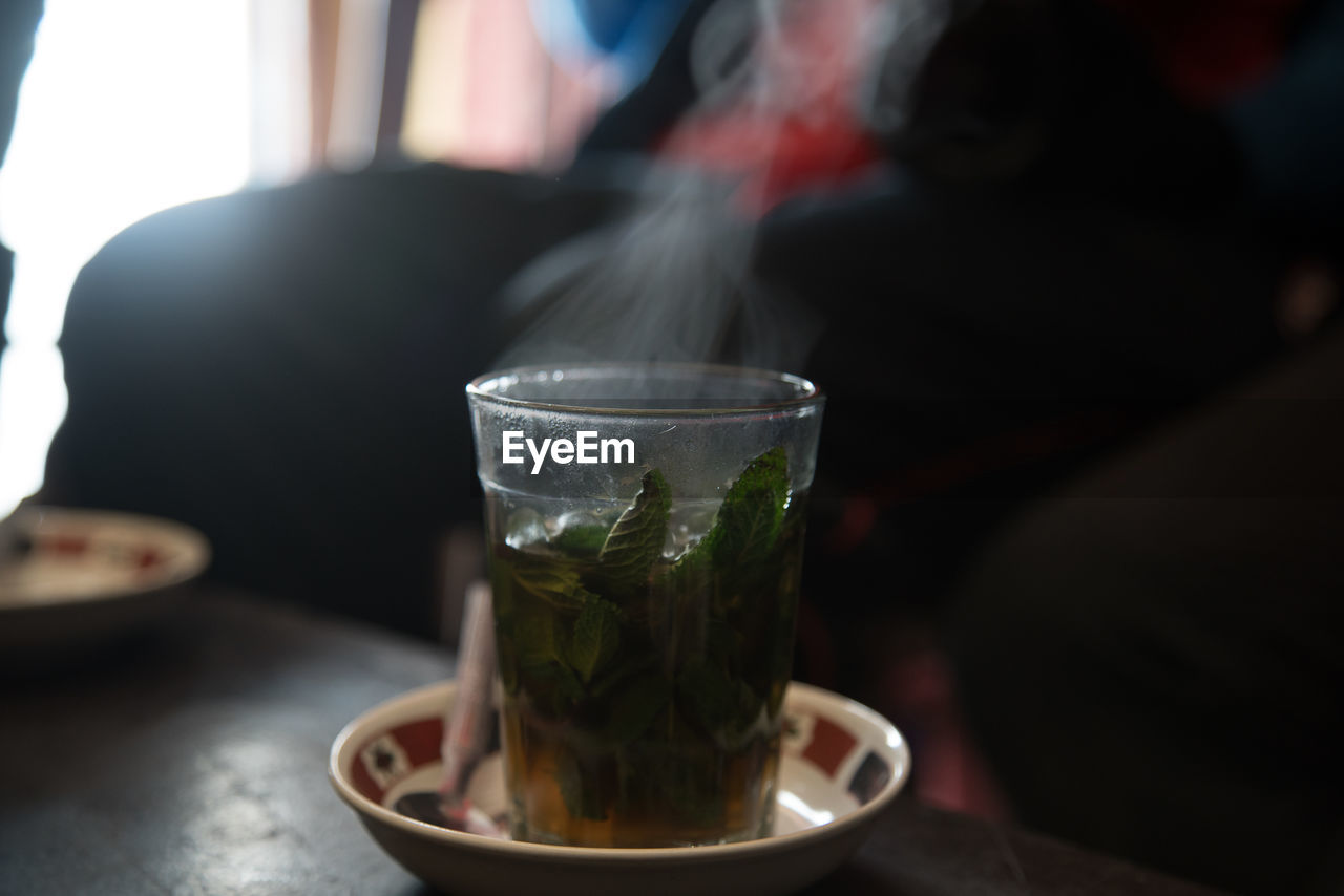 CLOSE-UP OF TEA IN GLASS ON TABLE