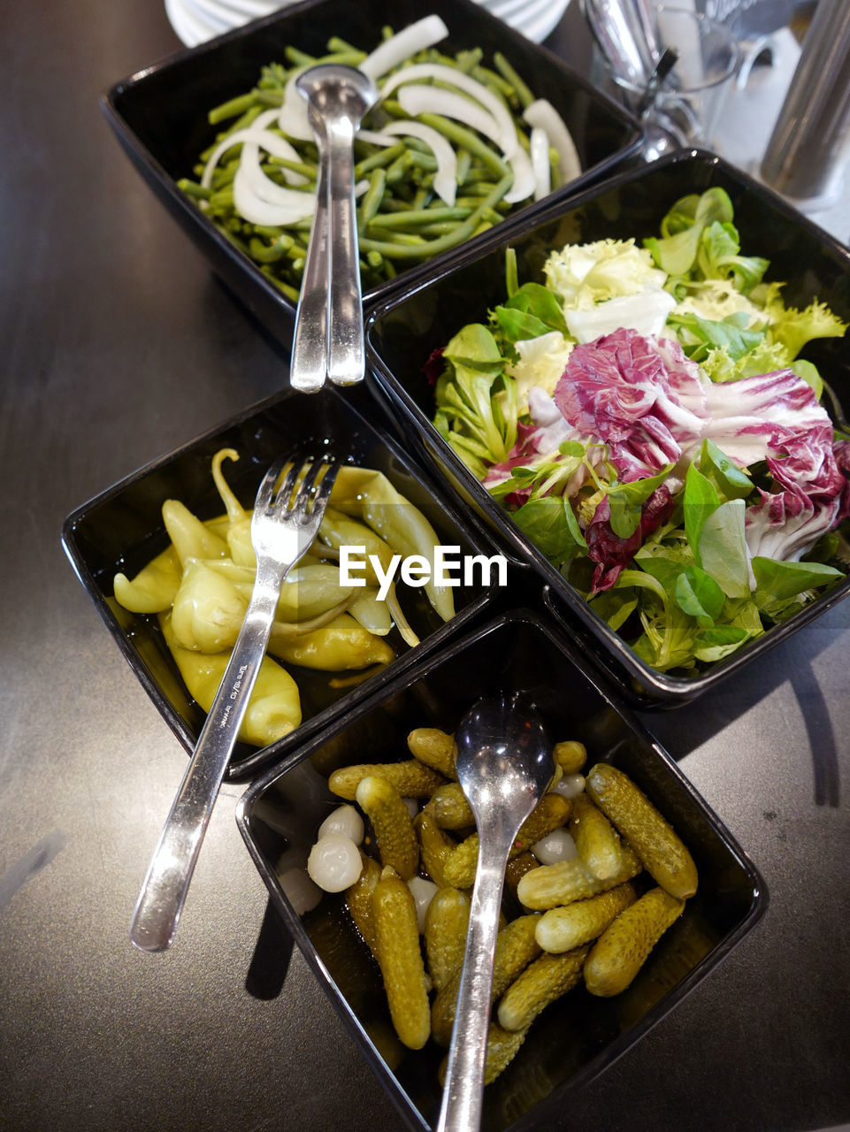 High angle view of vegetable salads served on table