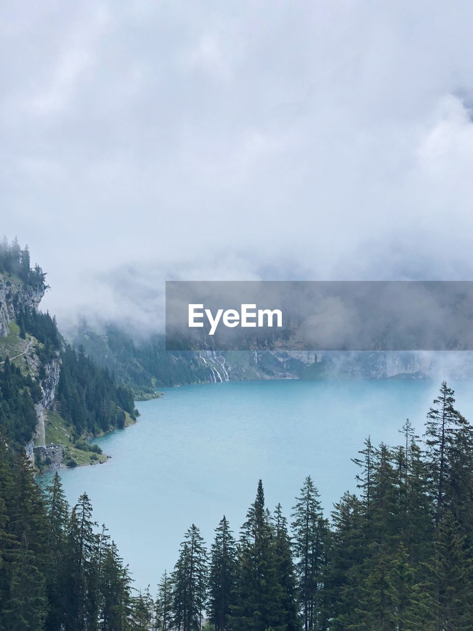 Scenic view of lake and trees against sky