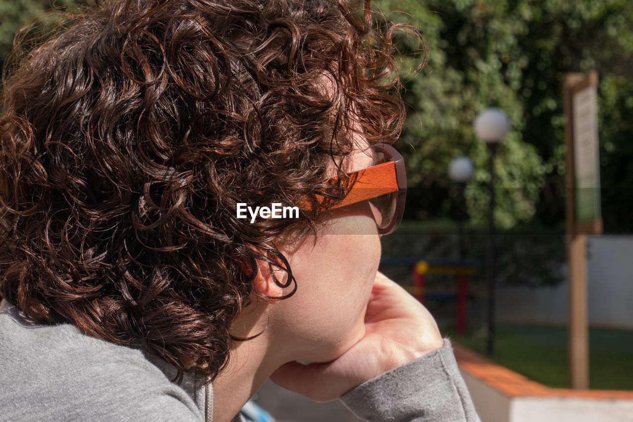 Close-up portrait of young woman wearing sunglasses