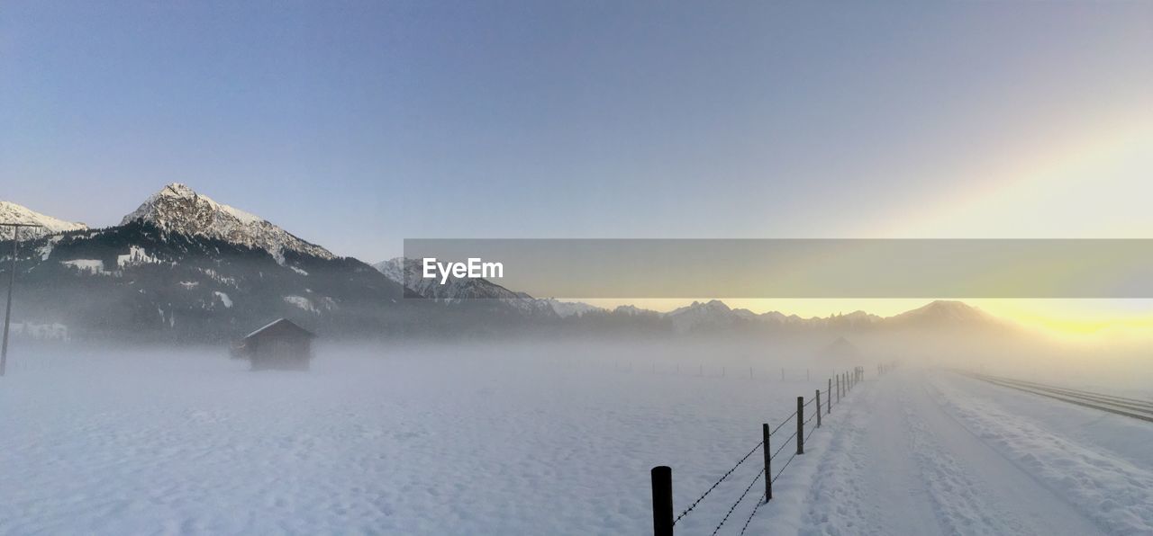 Scenic view of snowcapped mountains against clear sky