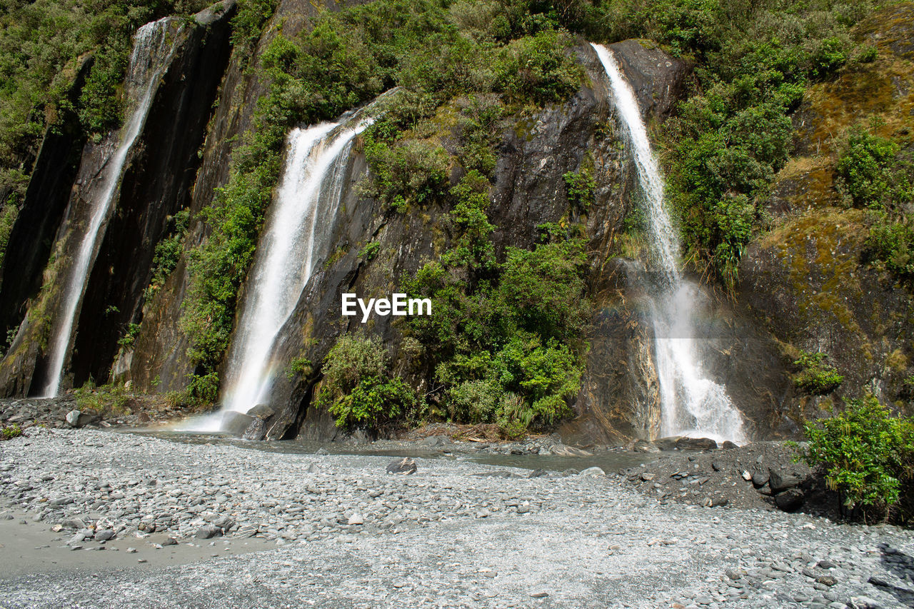 waterfall, water, scenics - nature, beauty in nature, motion, long exposure, nature, plant, tree, body of water, flowing water, environment, rock, land, forest, water feature, no people, non-urban scene, splashing, blurred motion, flowing, outdoors, travel destinations, power in nature, day, watercourse, falling, rock formation, idyllic, travel, tourism, landscape, falling water, river