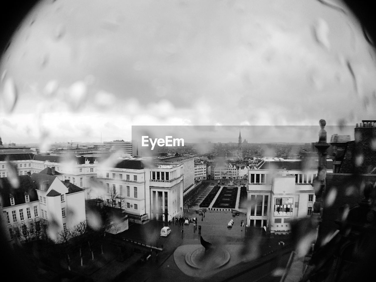 City viewed through wet window glass