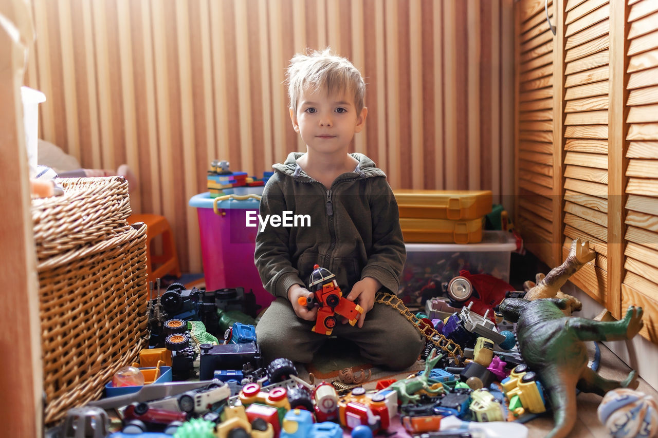 Portrait of boy playing with toys at home