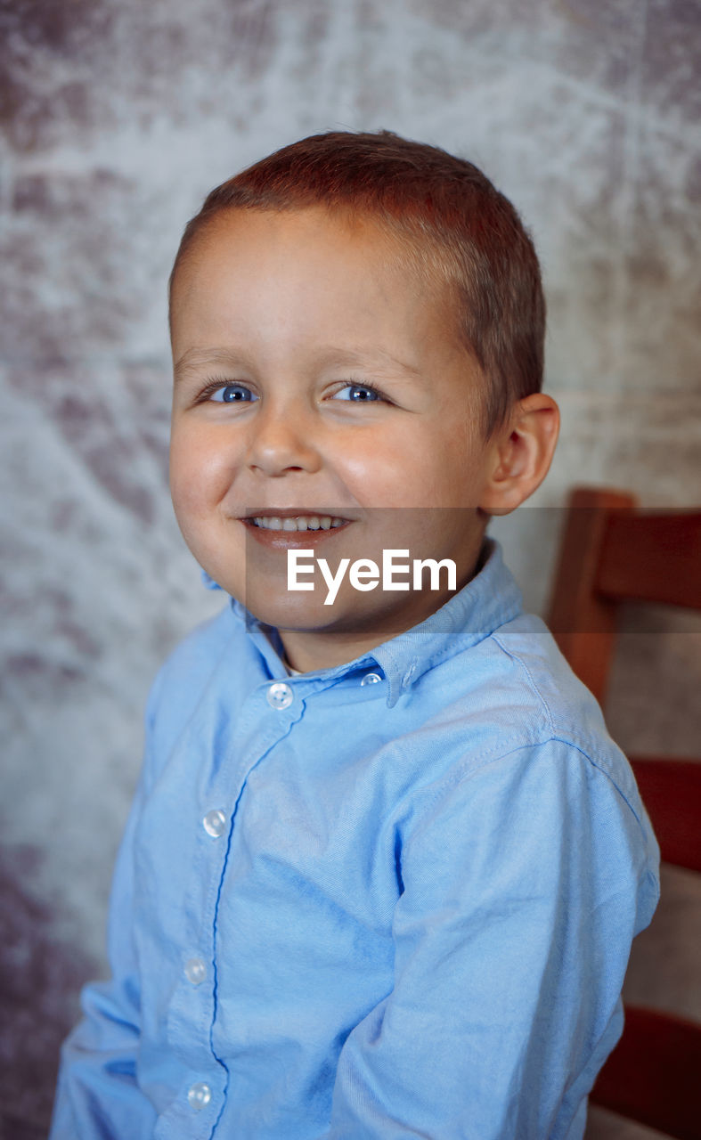 childhood, child, portrait, men, one person, looking at camera, person, smiling, happiness, toddler, emotion, cute, blue, portrait photography, baby, indoors, innocence, cheerful, waist up, shirt, casual clothing, standing, human face, senior adult, skin, clothing, positive emotion, brown eyes, lifestyles, front view, focus on foreground
