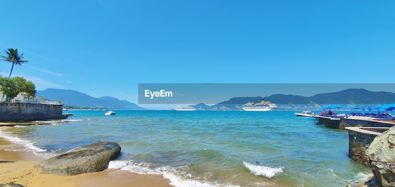 Scenic view of sea against clear blue sky