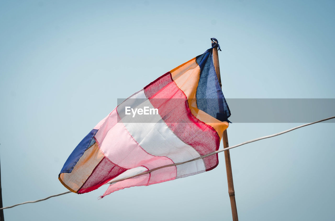 LOW ANGLE VIEW OF FLAG AGAINST CLEAR SKY