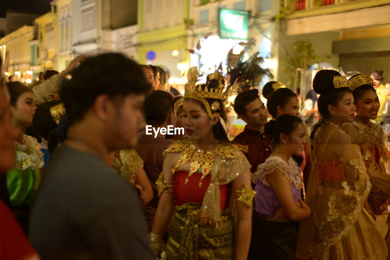 GROUP OF PEOPLE IN MARKET DURING FESTIVAL