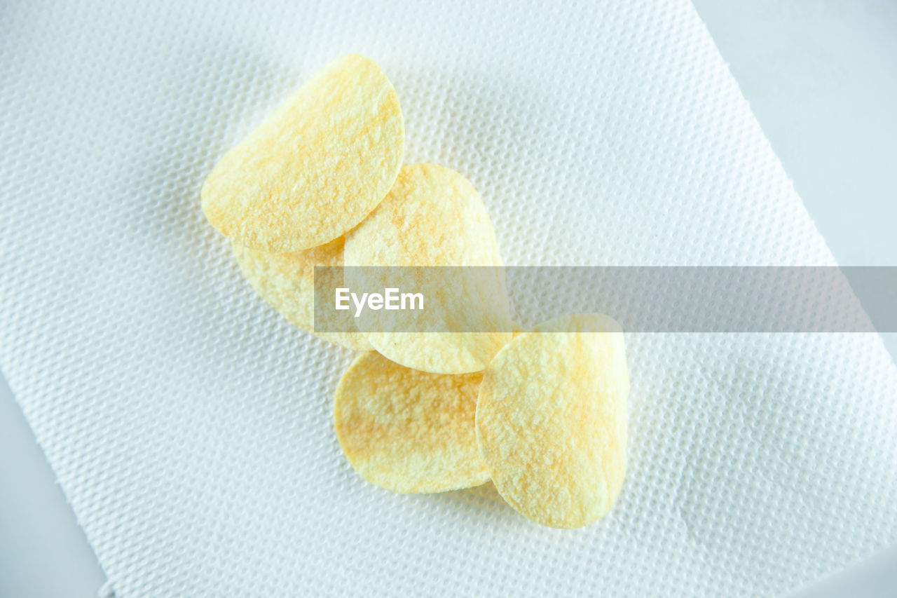 High angle view of potato chip on tissue paper