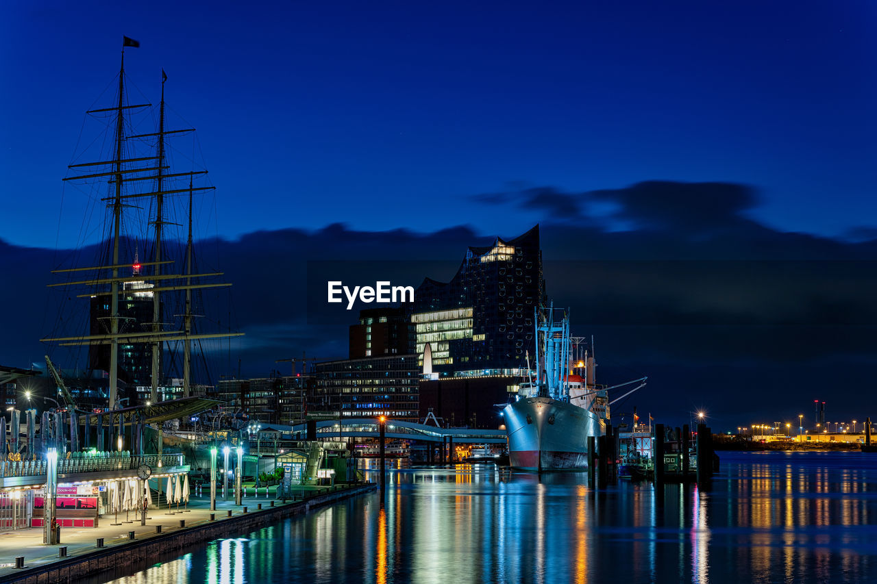 SAILBOATS IN HARBOR AT NIGHT