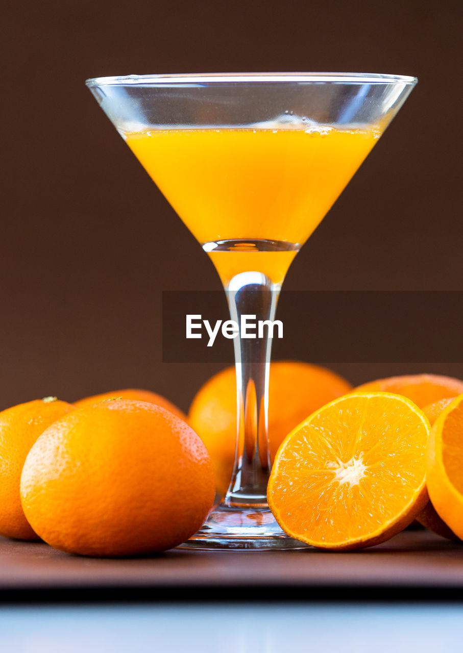 food and drink, fruit, orange color, food, citrus fruit, refreshment, drink, healthy eating, glass, cocktail, orange, alcohol, freshness, alcoholic beverage, studio shot, produce, no people, juice, martini glass, household equipment, drinking glass, slice, distilled beverage, indoors, wellbeing, still life, close-up, martini, tangerine, tropical fruit