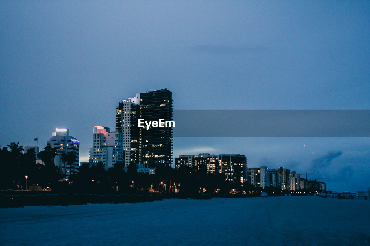 horizon, architecture, city, building exterior, built structure, sky, dusk, skyline, building, illuminated, office building exterior, skyscraper, night, landscape, evening, cityscape, water, urban skyline, nature, travel destinations, reflection, no people, sea, city life, residential district, outdoors, cloud, blue, travel, downtown, urban area, downtown district, sunset