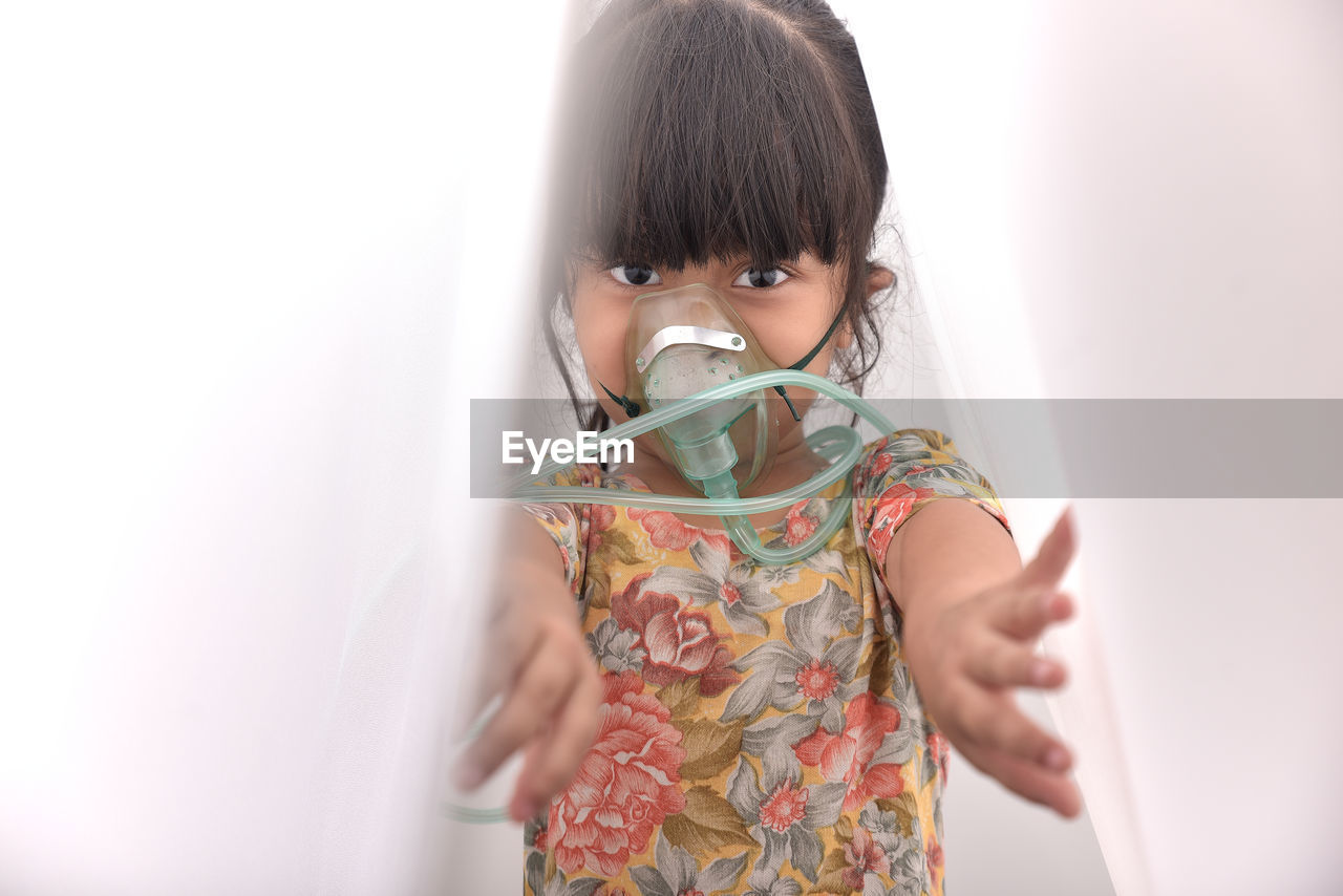 Portrait of girl wearing nebulizer