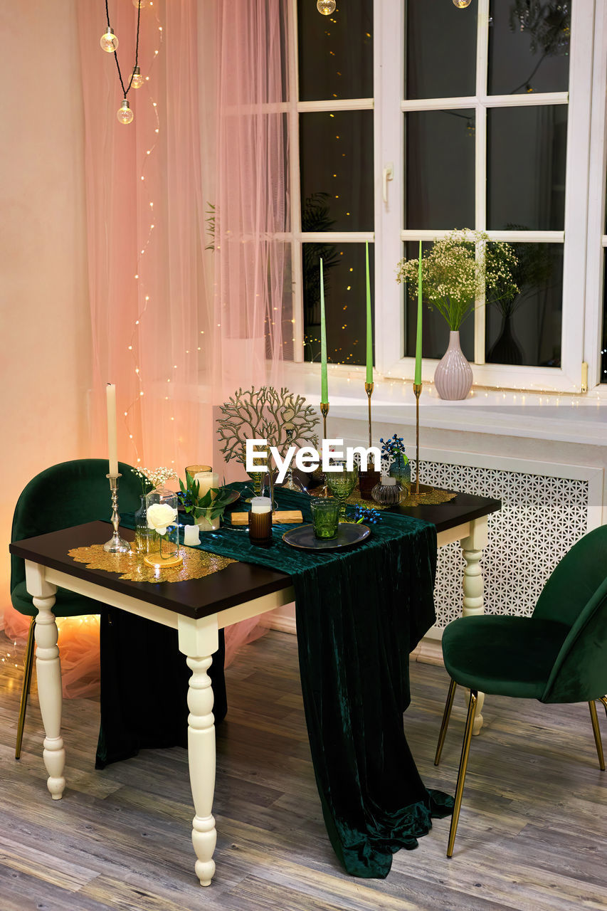 Romantic dinner table setting with festive lights