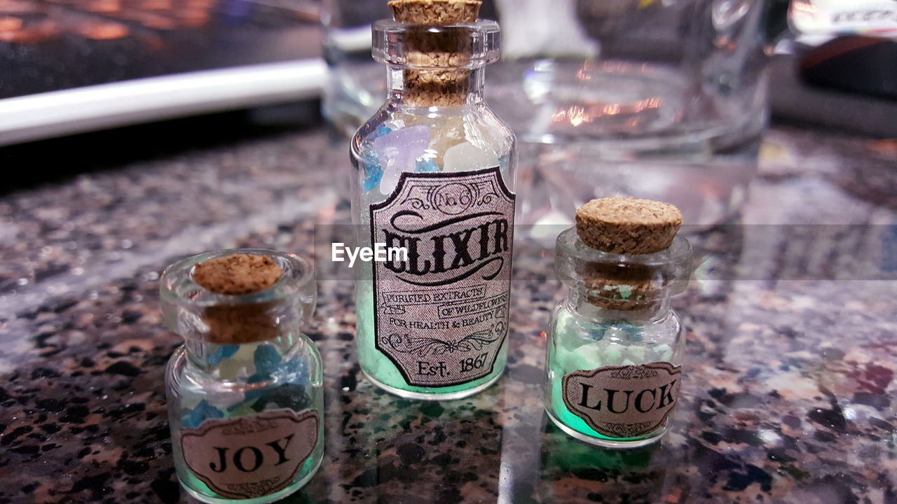 HIGH ANGLE VIEW OF GLASS JAR ON TABLE AT HOME