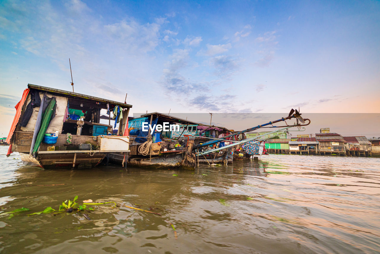 FISHING BOAT MOORED AT BEACH AGAINST SKY