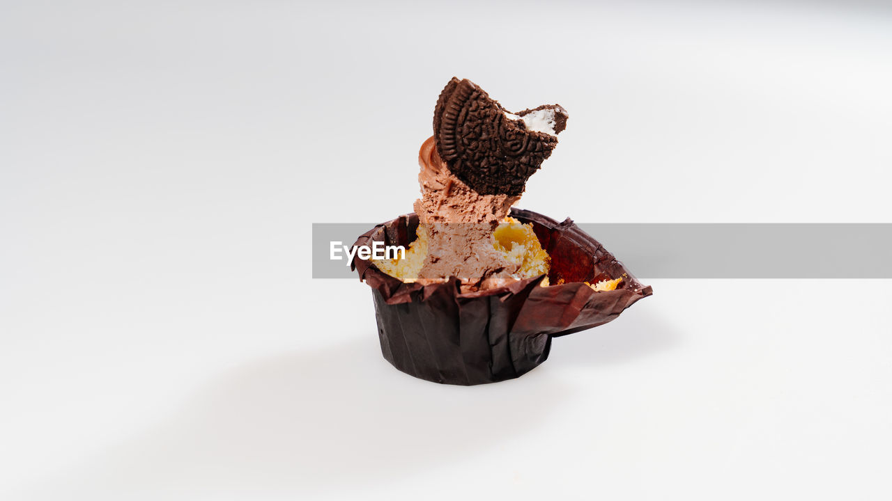 CLOSE-UP OF CHOCOLATE CAKE ON WHITE BACKGROUND