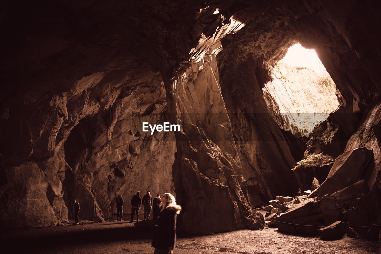 TOURISTS ON ROCK FORMATION
