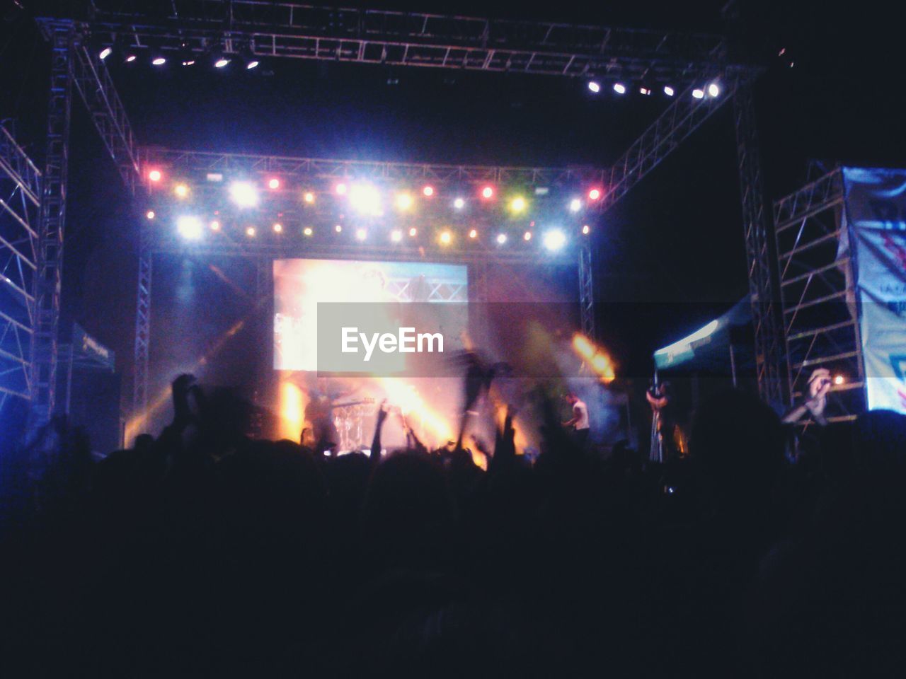 PEOPLE ENJOYING AT CONCERT