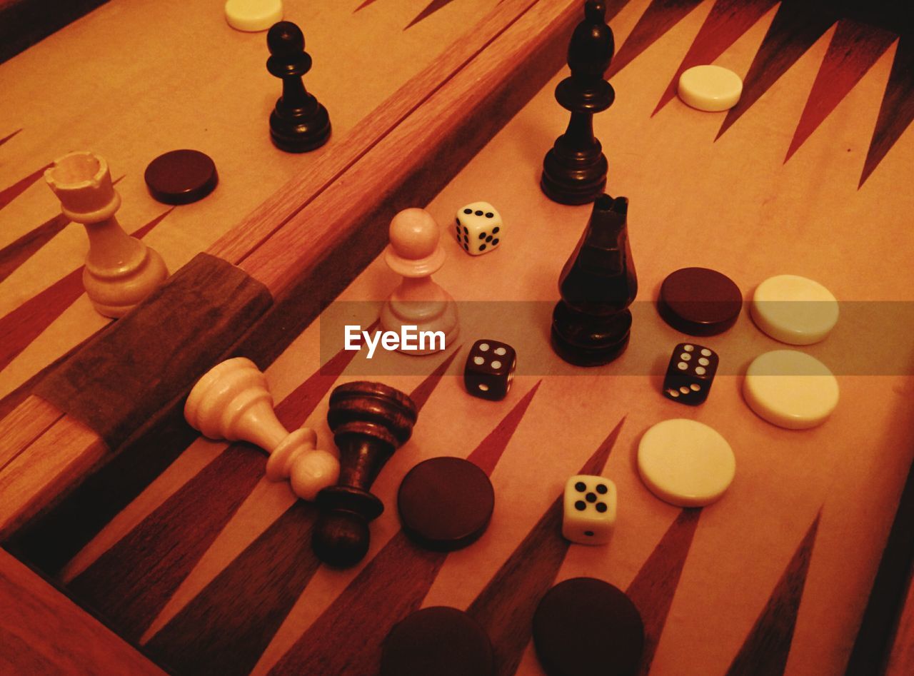 High angle view of chess pieces and dices on table