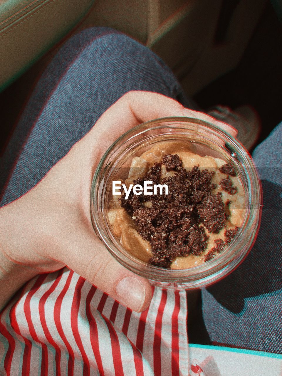 MIDSECTION OF WOMAN HOLDING ICE CREAM IN CUP