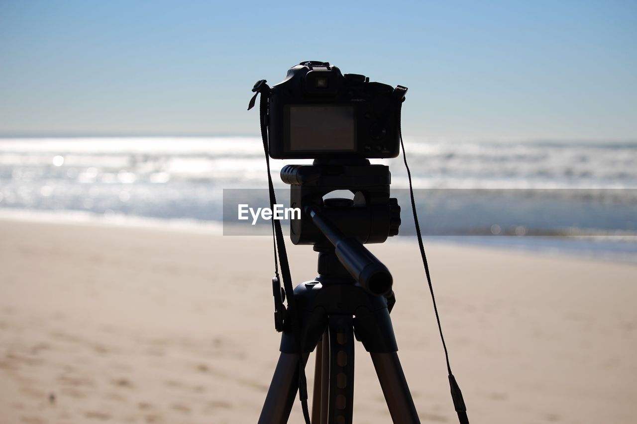 Close-up of digital camera on tripod at beach