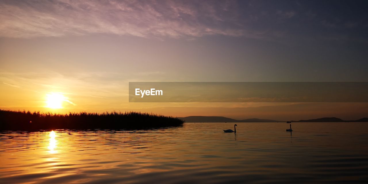 SCENIC VIEW OF LAKE DURING SUNSET