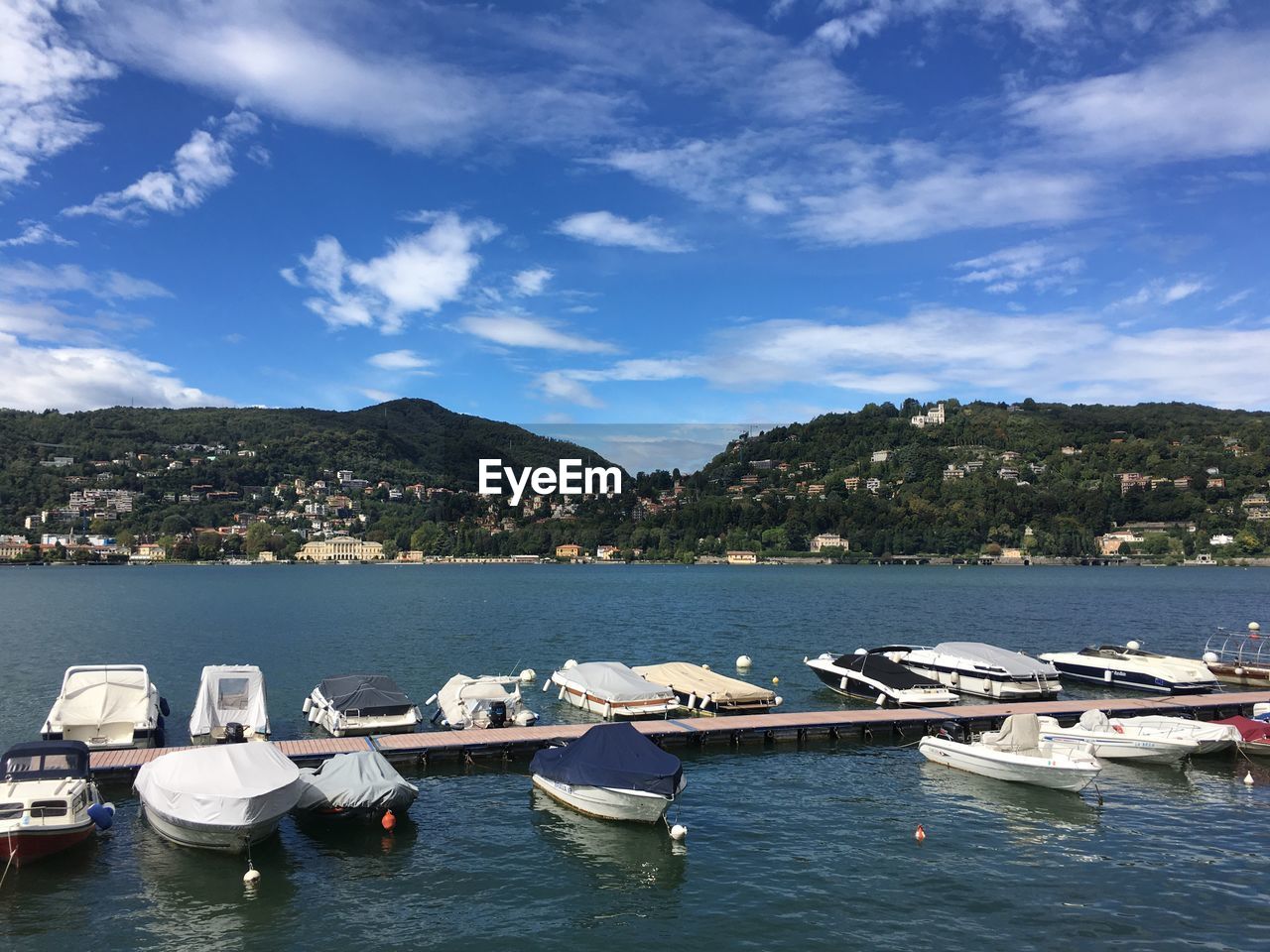 Boats moored in lake against sky