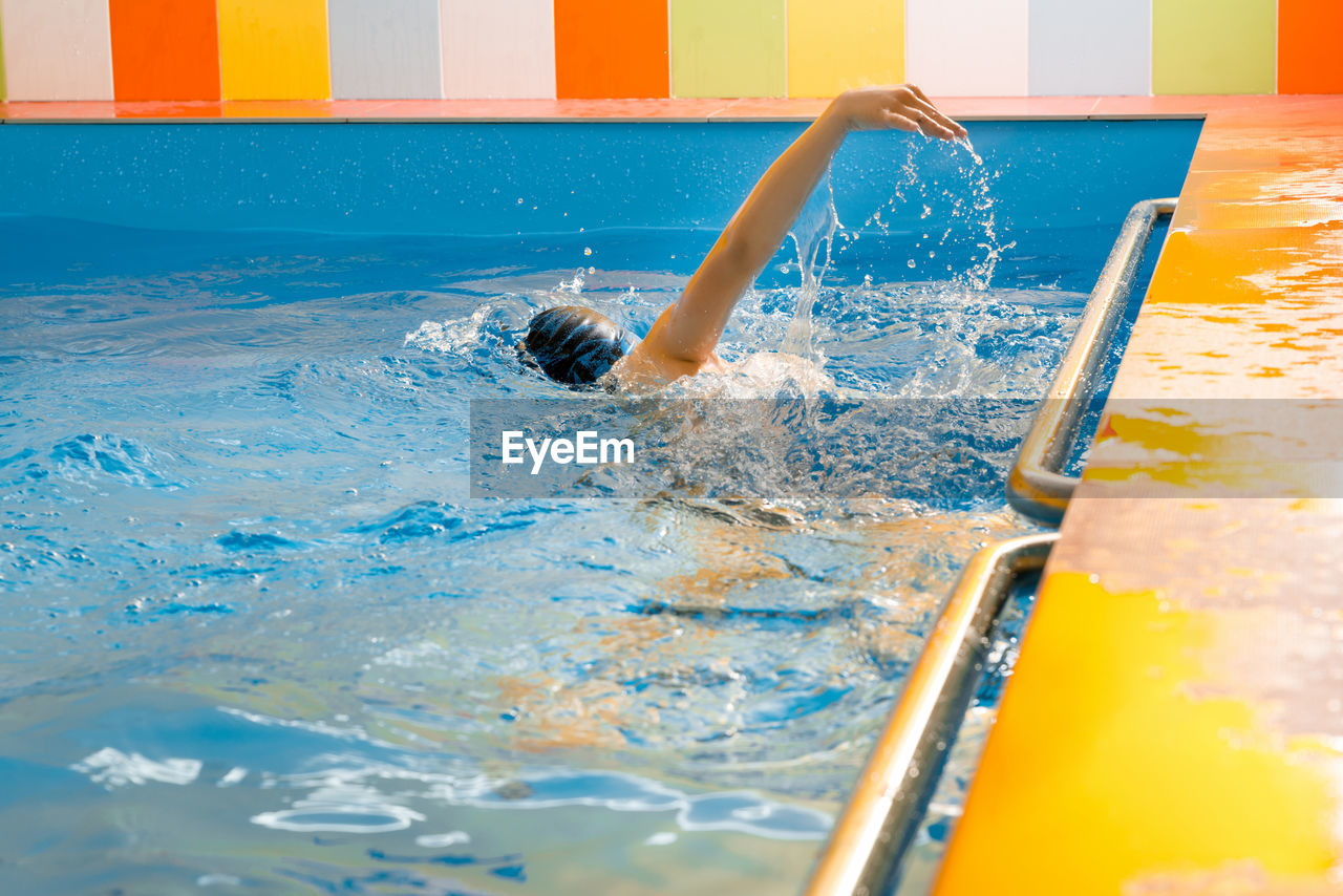 Man swimming in pool