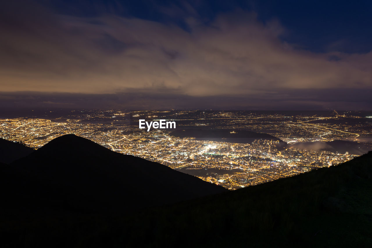 Aerial view of city against sky at night