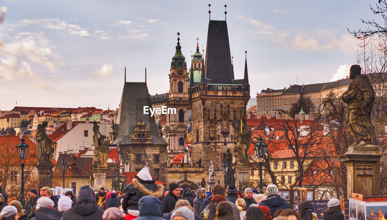 People at st vitus cathedral against sky