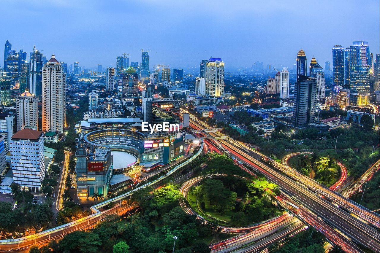 High angle view of illuminated cityscape against sky