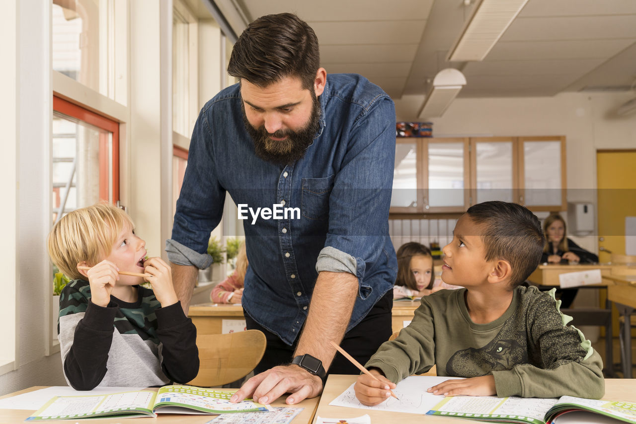 Teacher with boys in classroom