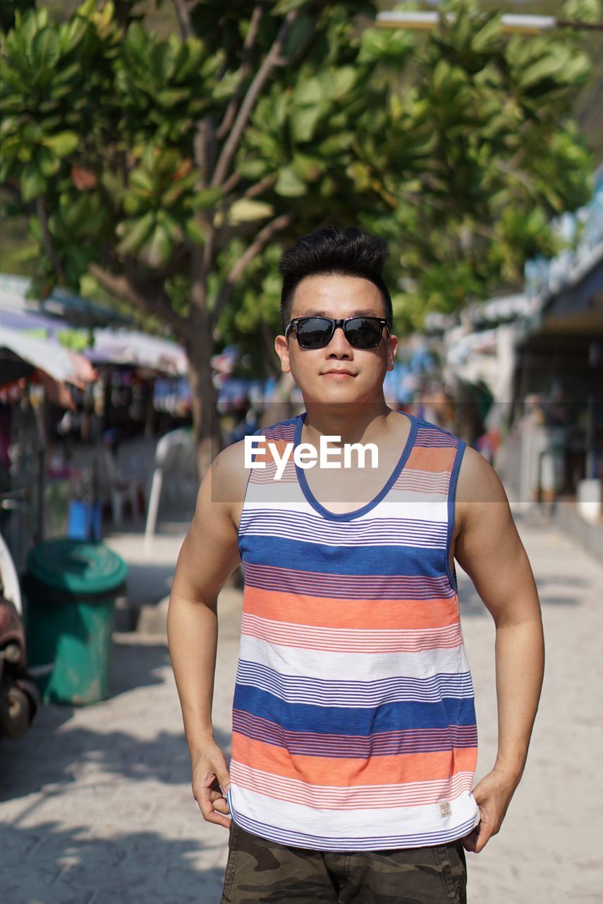 Portrait of man wearing sunglasses standing outdoors