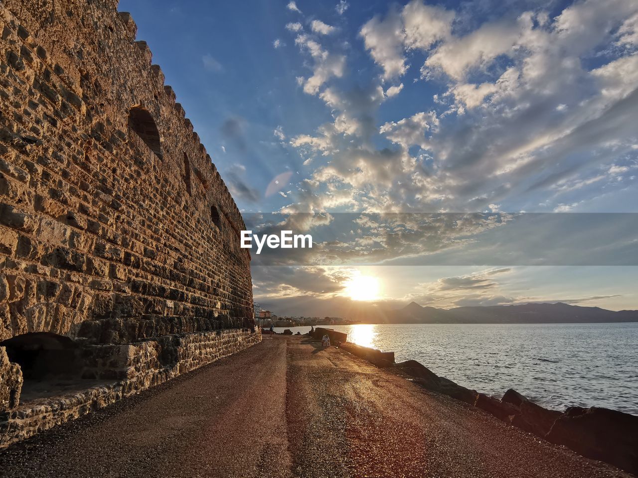 Scenic view of fortress sea against sky during sunset