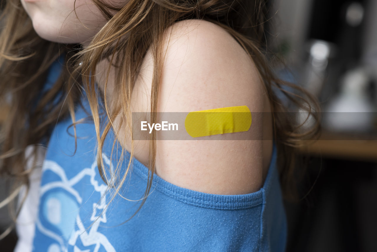 Little girl with a band-aid on her hands, vaccinated against coronavirus infection. vaccination