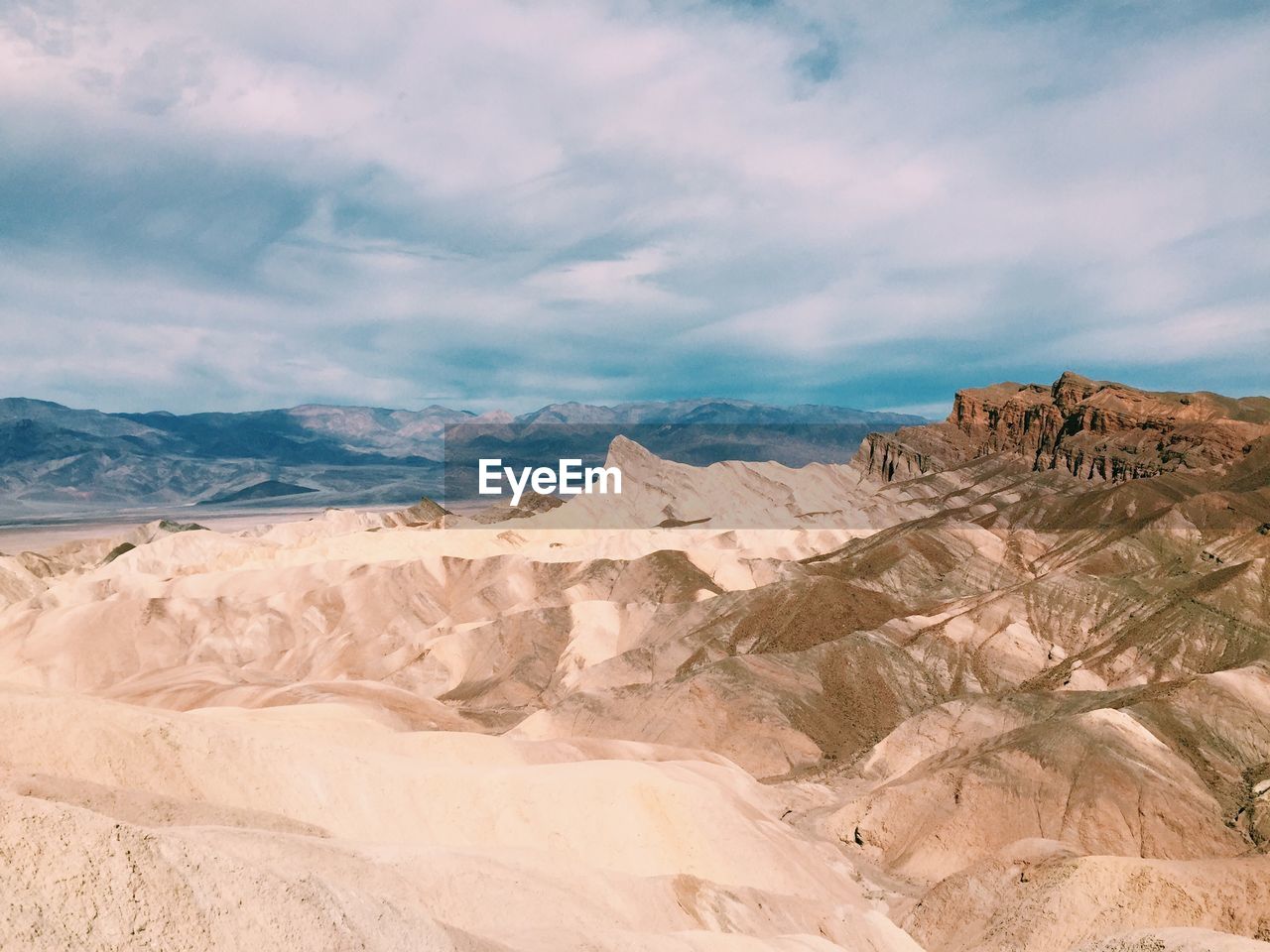 Scenic view of mountains against cloudy sky