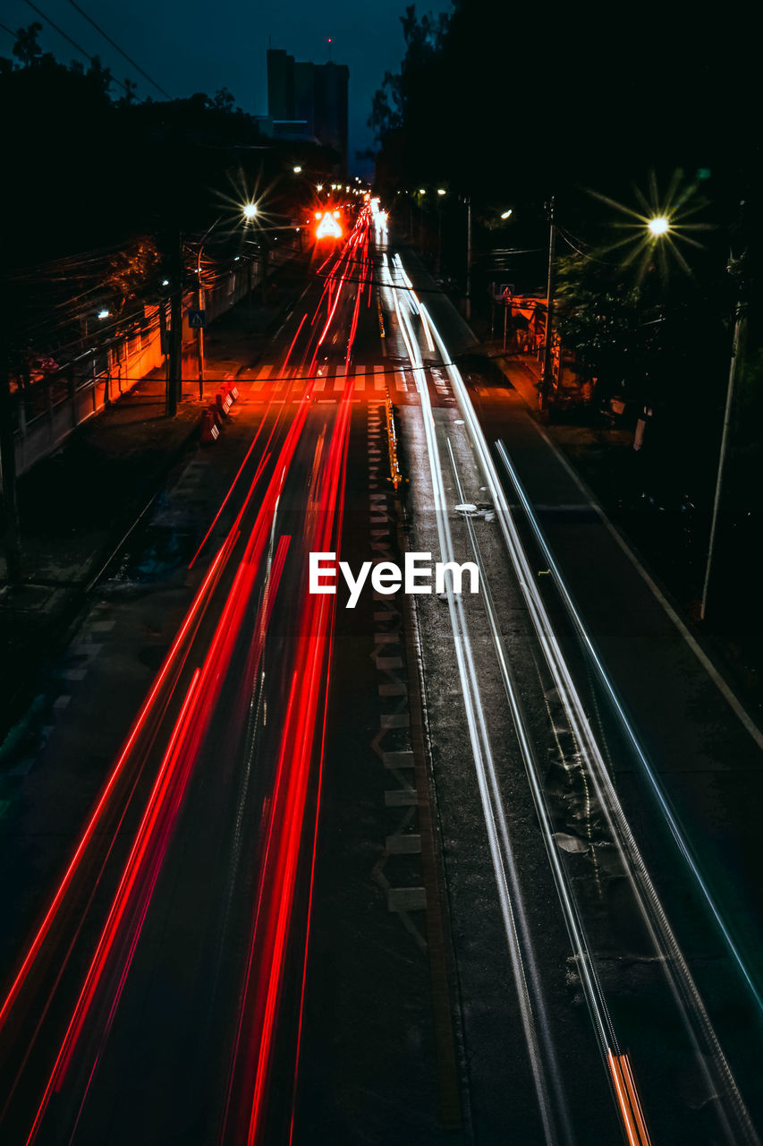 High angle view of light trails on road at night