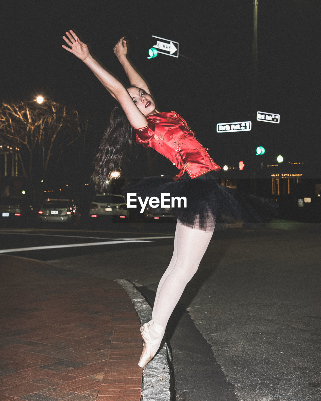 Ballet dancer in city at night