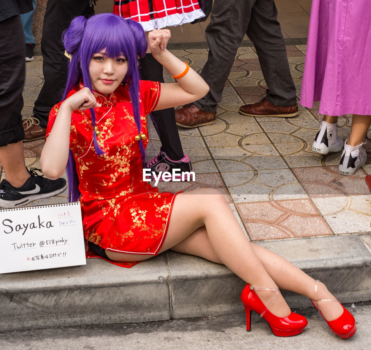 LOW SECTION OF PEOPLE SITTING IN TRADITIONAL SHOES